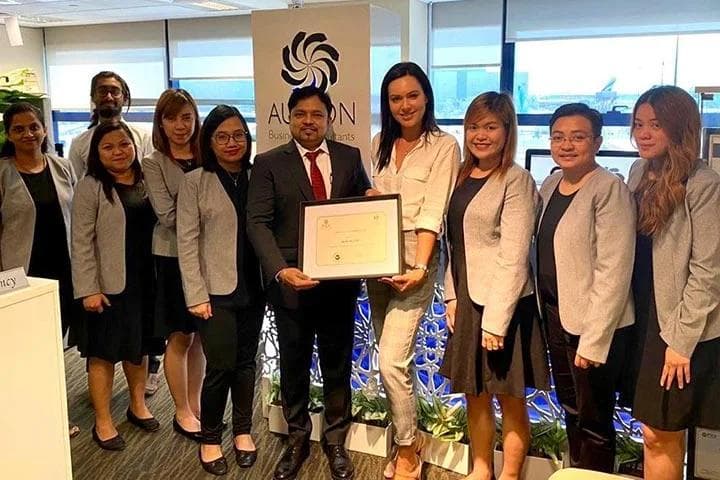 AURION receiving an Appreciation Award from Justina Pereckate, IFZA's Head of Client Relations